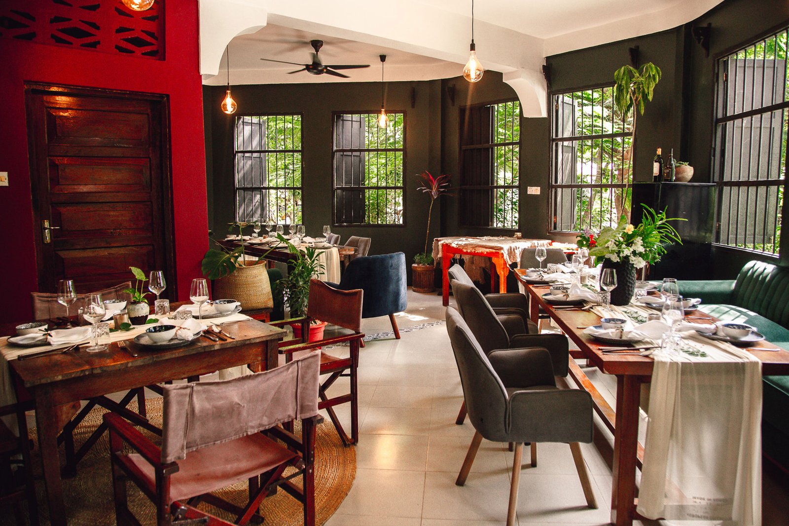The dining space at Basil, surrounded by plants in Paje, Zanzibar