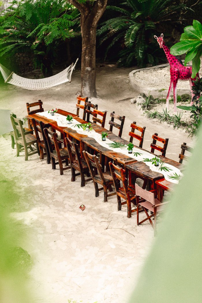 A long banquet table set for a celebration at Basil, Paje