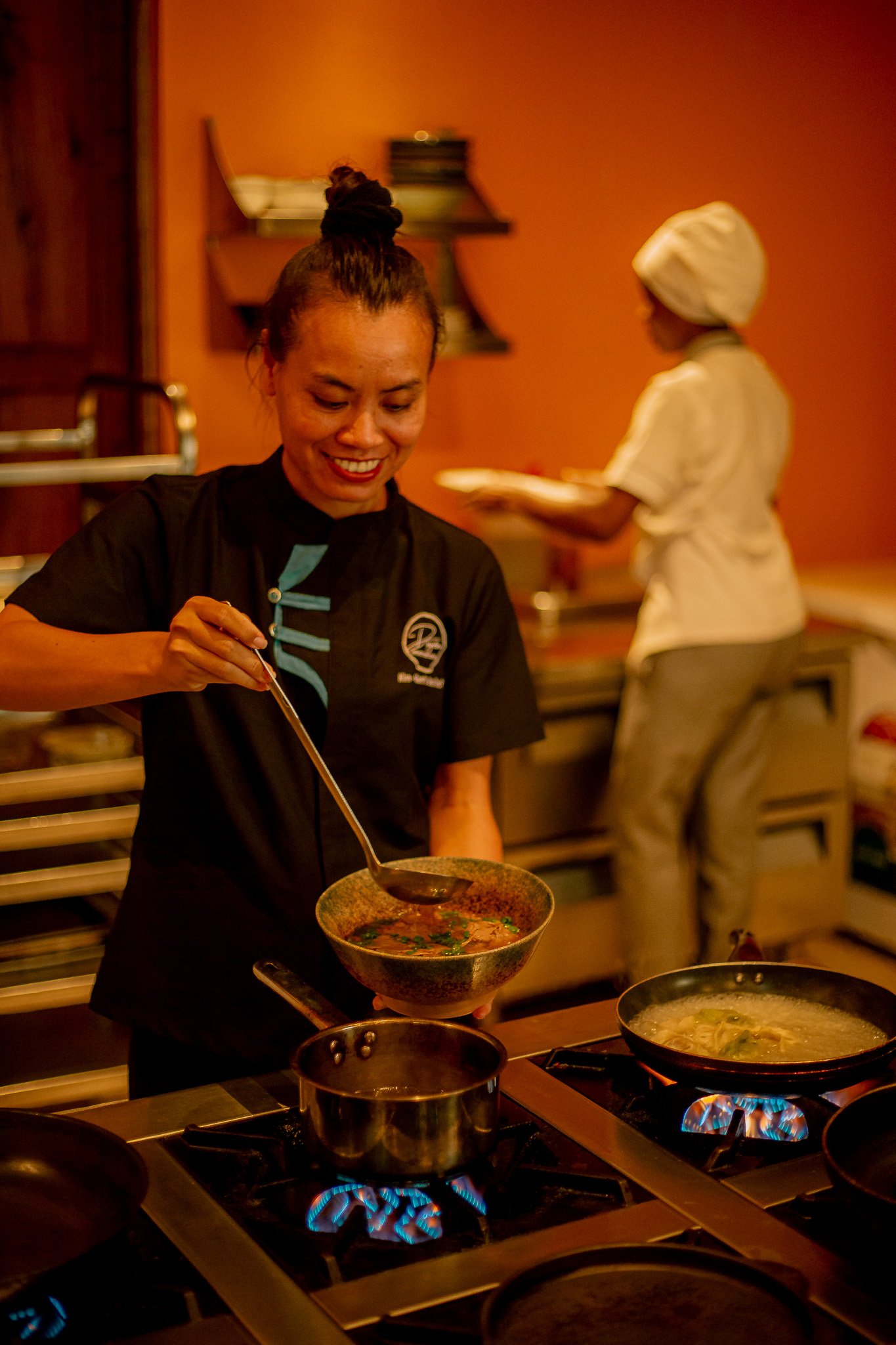 Kim Anh cooking pho — founder of Kim Dining Concept